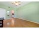 Bedroom with hardwood floors and ceiling fan, leading to an ensuite bathroom at 1007 Gondola Park Dr # 1007, Venice, FL 34292