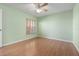 Well-lit bedroom with hardwood floors, a ceiling fan, and a large window with views of the outdoors at 1007 Gondola Park Dr # 1007, Venice, FL 34292