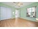 Bedroom featuring wood floors, a ceiling fan, and large windows at 1007 Gondola Park Dr # 1007, Venice, FL 34292