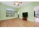Bedroom with ceiling fan, hardwood flooring, neutral paint, large window, and television at 1007 Gondola Park Dr # 1007, Venice, FL 34292