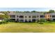 Exterior view of two-story condo with screened lanai overlooking green space at 1007 Gondola Park Dr # 1007, Venice, FL 34292