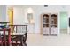 Bright dining area with tile floors and modern built-in shelving, blending elegance with practicality at 1007 Gondola Park Dr # 1007, Venice, FL 34292