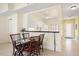 Cozy dining area with a glass table and seating for four, located adjacent to the bright kitchen at 1007 Gondola Park Dr # 1007, Venice, FL 34292
