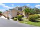 Attractive townhome featuring a well-manicured lawn, lush landscaping, and an attached garage at 1007 Gondola Park Dr # 1007, Venice, FL 34292