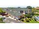 Beautiful view of townhomes showcasing lush landscaping and a green tile roof at 1007 Gondola Park Dr # 1007, Venice, FL 34292