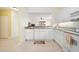 Kitchen with granite counters, white appliances, and bar access to the living area at 1007 Gondola Park Dr # 1007, Venice, FL 34292