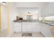 Kitchen featuring granite countertops and dishwasher, opens to living room through serving hatch at 1007 Gondola Park Dr # 1007, Venice, FL 34292