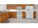 This kitchen features wooden cabinets, a white refrigerator, and matching appliances at 1007 Gondola Park Dr # 1007, Venice, FL 34292