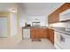 This kitchen features wooden cabinets, white appliances, and an open layout at 1007 Gondola Park Dr # 1007, Venice, FL 34292