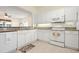 Well-lit kitchen with white appliances and plenty of counter space, open to living room at 1007 Gondola Park Dr # 1007, Venice, FL 34292