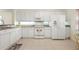 Clean white kitchen features modern appliances, granite countertops, and lots of storage space at 1007 Gondola Park Dr # 1007, Venice, FL 34292