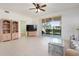 Open-concept living room with tiled floors, backyard views, and built in shelving, creating an inviting space at 1007 Gondola Park Dr # 1007, Venice, FL 34292