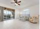 Bright living room with tiled floor, ceiling fan, and sliding door to patio bringing in natural light at 1007 Gondola Park Dr # 1007, Venice, FL 34292