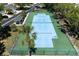 Aerial shot of a well-maintained tennis court with new net inside a fenced area at 1007 Gondola Park Dr # 1007, Venice, FL 34292