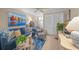 Cozy living room featuring a comfortable blue sofa and coastal-themed decor at 1100 Tarpon Center Dr # 104, Venice, FL 34285
