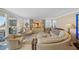 Comfortable living room with plush seating, stylish decor, and slider to balcony with ocean views at 1100 Tarpon Center Dr # 104, Venice, FL 34285
