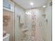Modern bathroom shower featuring glass enclosure and designer tile at 1100 Tarpon Center Dr # 104, Venice, FL 34285