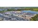 An aerial view of a community building under construction, featuring surrounding homes and lake at 11239 Boundless Ter, Venice, FL 34293