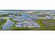 Expansive aerial view of a Primary-planned community featuring beautiful homes surrounding serene lakes and lush landscaping at 11239 Boundless Ter, Venice, FL 34293