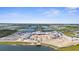 An aerial view shows a community building under construction and the lakefront property of the new community at 11239 Boundless Ter, Venice, FL 34293