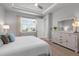 Comfortable bedroom with a ceiling fan and a large window offering lots of natural light at 11239 Boundless Ter, Venice, FL 34293