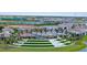 Inviting entrance with lush landscaping, modern signage, and palm trees welcomes residents to the Brightmore community at 11239 Boundless Ter, Venice, FL 34293