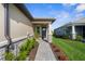 The home features a stone-accented front facade and a beautifully landscaped walkway to the front door at 11239 Boundless Ter, Venice, FL 34293
