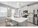 Spacious kitchen with modern appliances, a kitchen island, and a stylish design at 11239 Boundless Ter, Venice, FL 34293