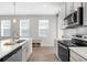 Bright kitchen featuring white countertops, stainless steel appliances, and ample natural light at 11239 Boundless Ter, Venice, FL 34293