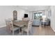 Open-concept living area with dining and living room furniture at 11239 Boundless Ter, Venice, FL 34293