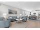 Inviting living area flowing into the dining space, showcasing modern decor, tile floors, and ample natural light at 11239 Boundless Ter, Venice, FL 34293
