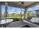 Relaxing screened-in patio with outdoor seating, ceiling fan, and tranquil view of landscaped backyard at 11239 Boundless Ter, Venice, FL 34293