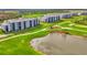 Multiple condo buildings nestled among lush green golf courses and shimmering lakes under a blue sky at 12140 Wellen Golf St # 401, Venice, FL 34293