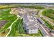 Aerial view of the property showcasing the building, parking, golf course, and surrounding landscape at 12140 Wellen Golf St # 401, Venice, FL 34293