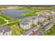 Modern condo building featuring covered parking, manicured landscaping, and water views from multiple floors at 12140 Wellen Golf St # 401, Venice, FL 34293