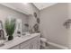 Bright bathroom featuring a modern vanity with white countertops and a decorative mirror at 12140 Wellen Golf St # 401, Venice, FL 34293