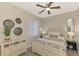 Cozy bedroom with neutral tones, decorative wall art, and a comfortable bed with patterned bedding at 12140 Wellen Golf St # 401, Venice, FL 34293