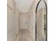 Bright hallway featuring neutral colors, stylish runner rug, and a full-length mirror reflecting bedroom at 12140 Wellen Golf St # 401, Venice, FL 34293