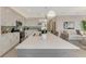 Spacious kitchen with white cabinetry, stainless appliances, and a large island with quartz countertops at 12140 Wellen Golf St # 401, Venice, FL 34293