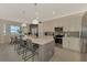 Open concept kitchen with a large island, stainless steel appliances, and a dining area at 12140 Wellen Golf St # 401, Venice, FL 34293
