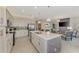 Gourmet kitchen with stainless steel appliances, large island, and views of the living area at 12140 Wellen Golf St # 401, Venice, FL 34293