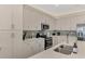 Stylish kitchen with stainless appliances, gray subway tile backsplash and bright cabinets at 12140 Wellen Golf St # 401, Venice, FL 34293