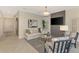 Comfortable living room with neutral color palette, stylish decor, and an entryway leading to the hallway at 12140 Wellen Golf St # 401, Venice, FL 34293