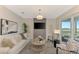 Bright living room featuring neutral colors, an accent wall, and sliding doors to a cozy patio at 12140 Wellen Golf St # 401, Venice, FL 34293