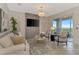 Cozy living room featuring neutral decor, accent wall, sliding glass door to patio with outdoor seating at 12140 Wellen Golf St # 401, Venice, FL 34293