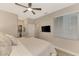 Bright main bedroom with a mounted TV, closet and ensuite bathroom at 12140 Wellen Golf St # 401, Venice, FL 34293