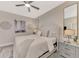 Serene main bedroom featuring a tufted headboard and neutral decor at 12140 Wellen Golf St # 401, Venice, FL 34293