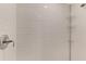 Sleek walk-in shower featuring white subway tile and chrome fixtures at 12140 Wellen Golf St # 401, Venice, FL 34293