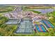 Aerial view of the community tennis and pickleball courts, with view of construction at 12140 Wellen Golf St # 401, Venice, FL 34293