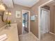 Bright bathroom featuring a neutral-toned vanity, shower, and view of the pool through a glass door at 1229 Waterside Ln, Venice, FL 34285
